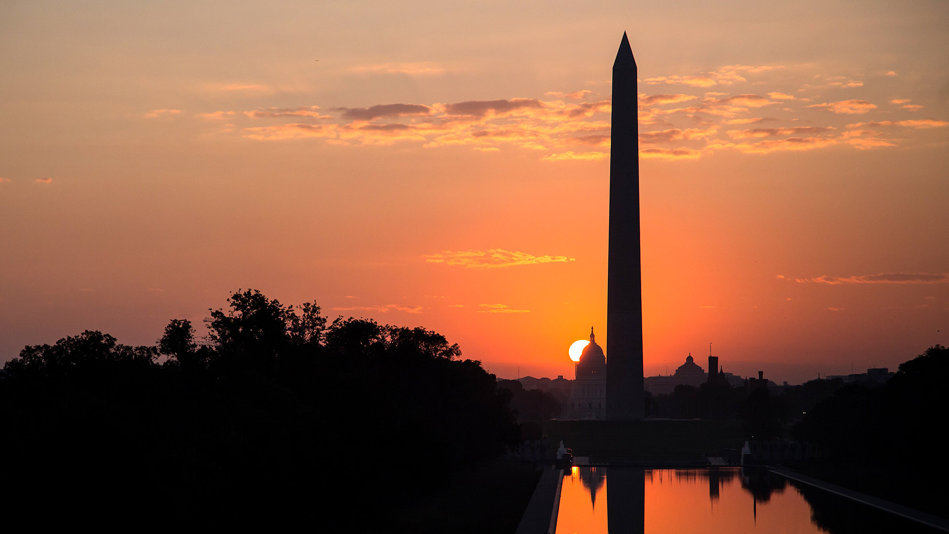 silhouette of the washington monument at dawn